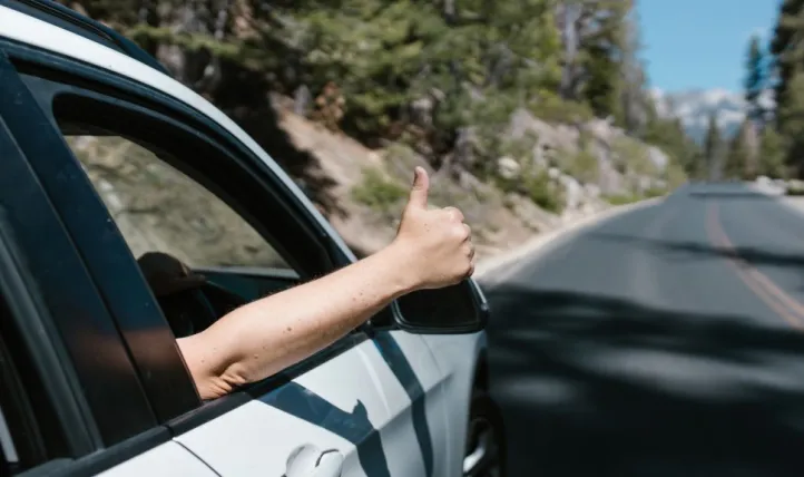Thumbs up out car window