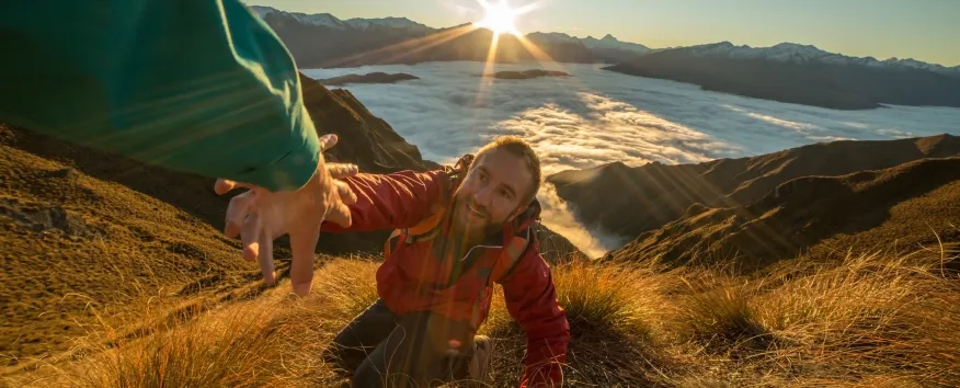 Helping man up mountain