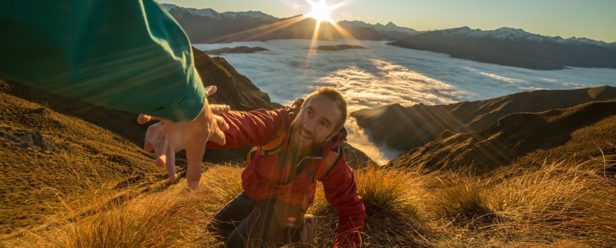 Helping man up mountain
