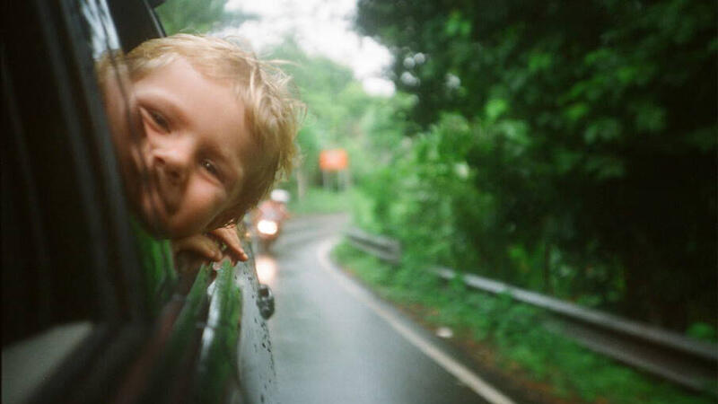 Child with head out car window