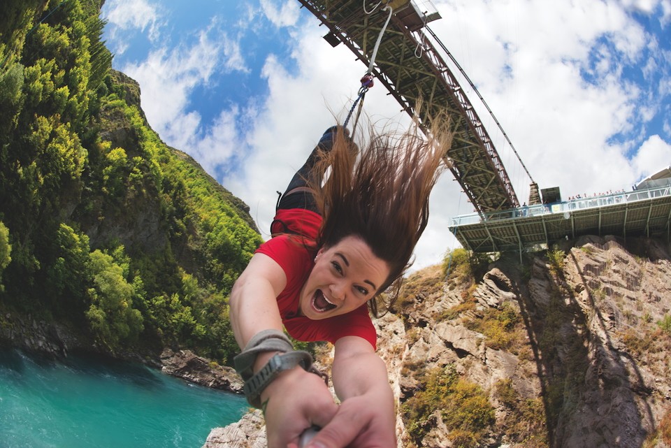 LAdy jumping off Kawarau Bridge Bungy laughing