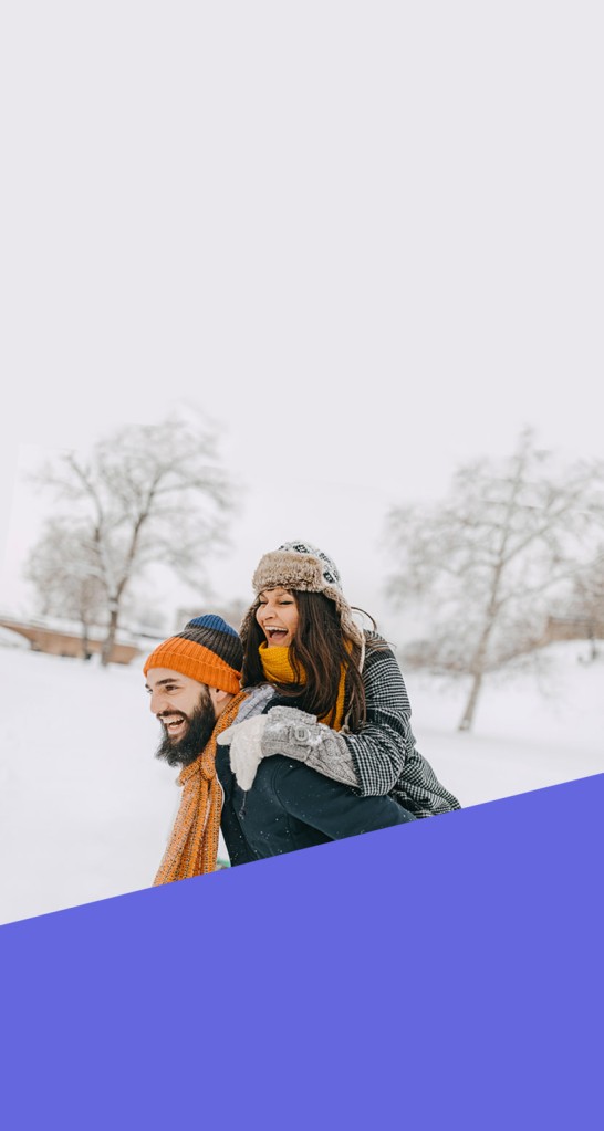 Snow field with person giving another person a piggy back