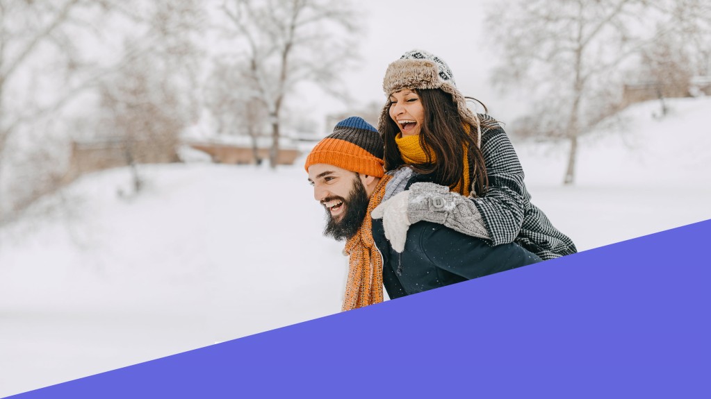 Snow field with person giving another person a piggy back